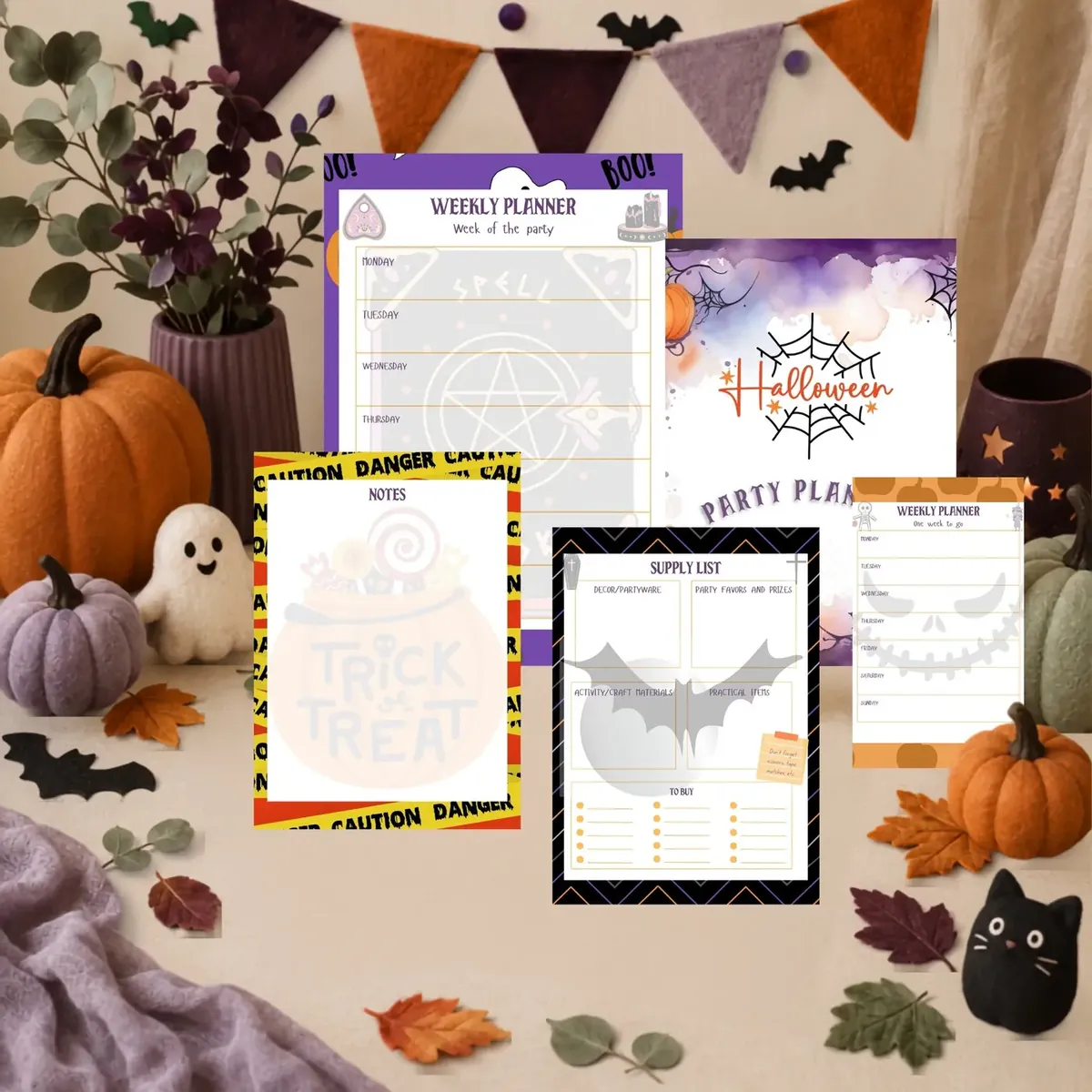 Halloween party planning sheets displayed in a festive tabletop scene
